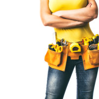 Handywoman,With,Folded,Arms,And,Tool,Belt,Isolated,On,White