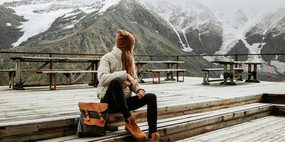 Girl,Traveler,With,Backpack,Enjoy,Mountain,Nature,Sitting,On,Wooden